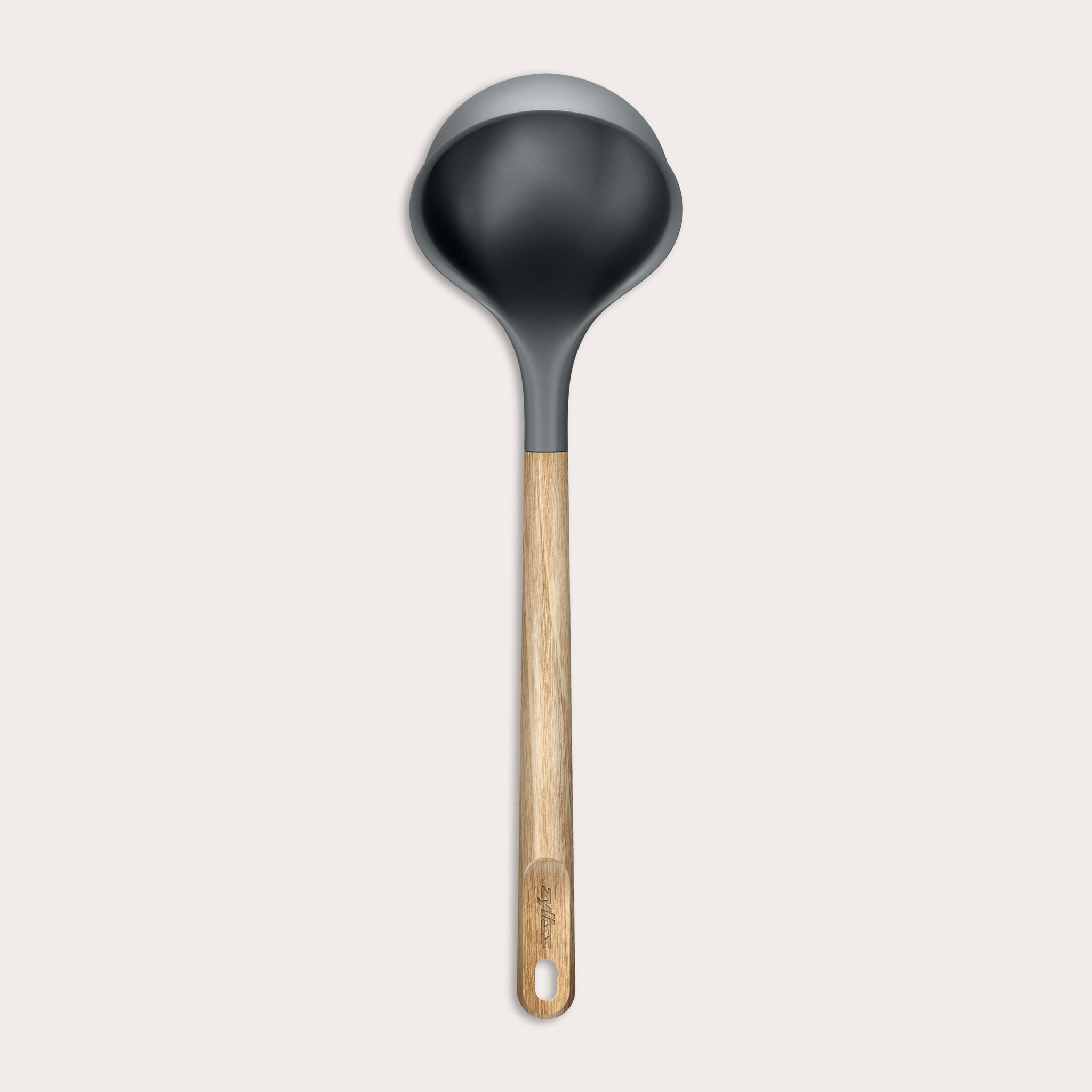 The Zyliss Oak Wood Ladle Large is black with a gray rim and a long oak handle featuring a hanging hole, displayed on a plain light background.