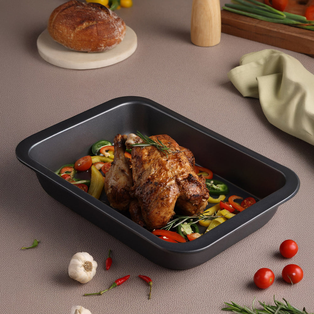 The Zyliss Non-Stick Oven Tray is a rectangular black carbon steel tray with rounded corners, shown empty on a light background.