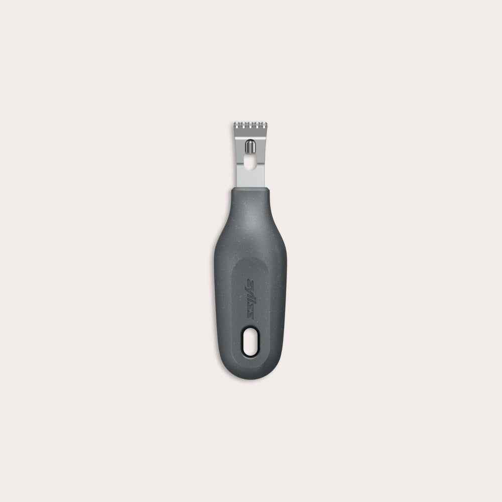 The Zyliss 2-In-1 Zester, made of stainless steel with a black ergonomic handle and a hole at the base, is an eco-friendly kitchen tool shown against a plain light background. 