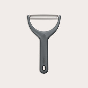The Zyliss Wide Peeler features a Y-shaped design, ergonomic handle, and horizontal stainless steel blade, shown against a simple light background. 