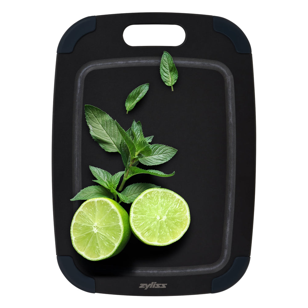 The Zyliss Wood Fibre Cutting Boards set features three nested black boards in different sizes, each with a handle slot and dark gray corner grips, made from eco-friendly recycled wood fibres and shown on a light background. #set of 3