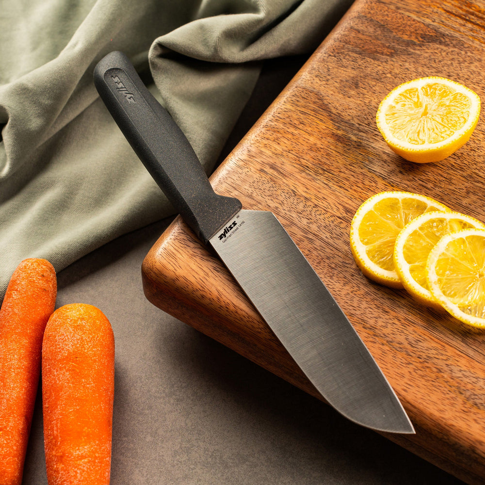 #15cm/6" The Zyliss Santoku Knife 15cm / 6 features a shiny silver blade and ergonomic handle, shown on a plain light background—a sustainable choice for any modern kitchen.