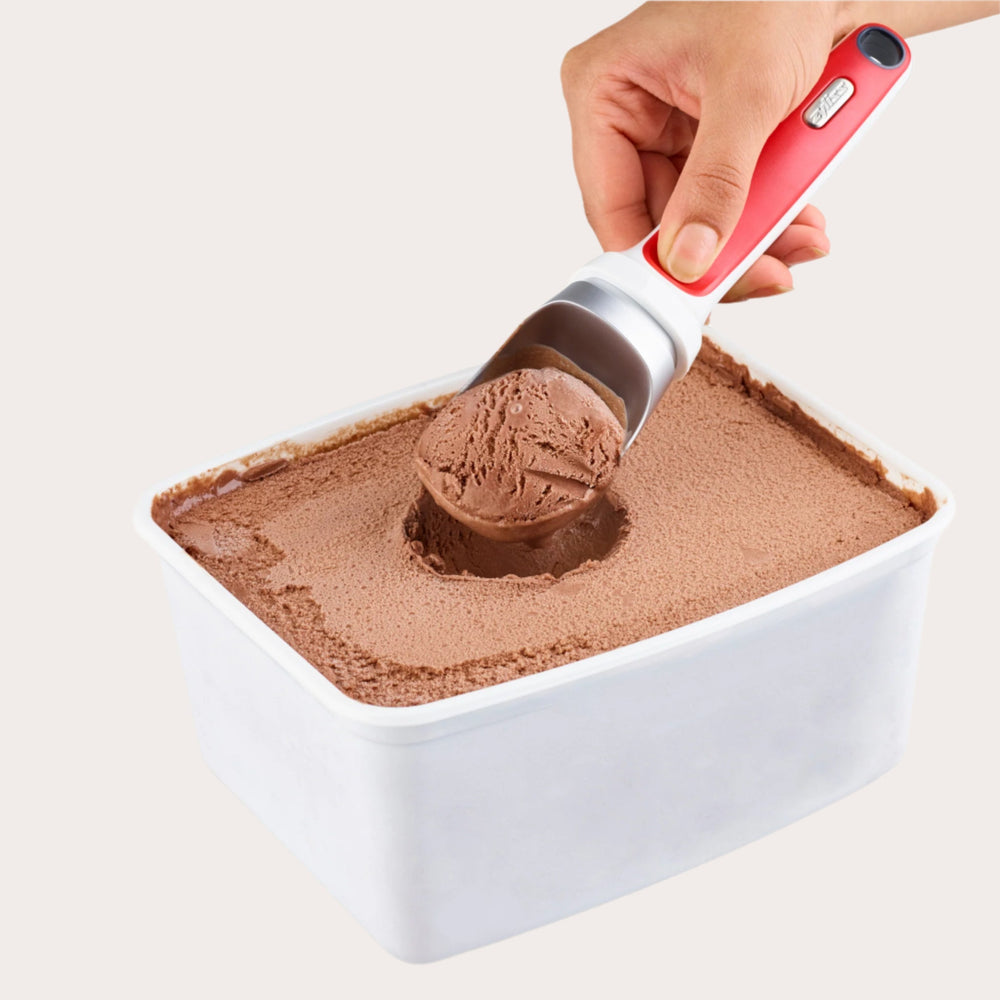 The Zyliss Right Scoop Ice Cream Scoop features a wide silver zinc alloy head and a red and white ergonomic handle with a small metallic label near the grip. 
