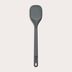 #large A Zyliss Spoontula with a dark gray, rounded silicone head and a long ergonomic handle, featuring a small hanging hole near the end, is displayed against a light background. #Large