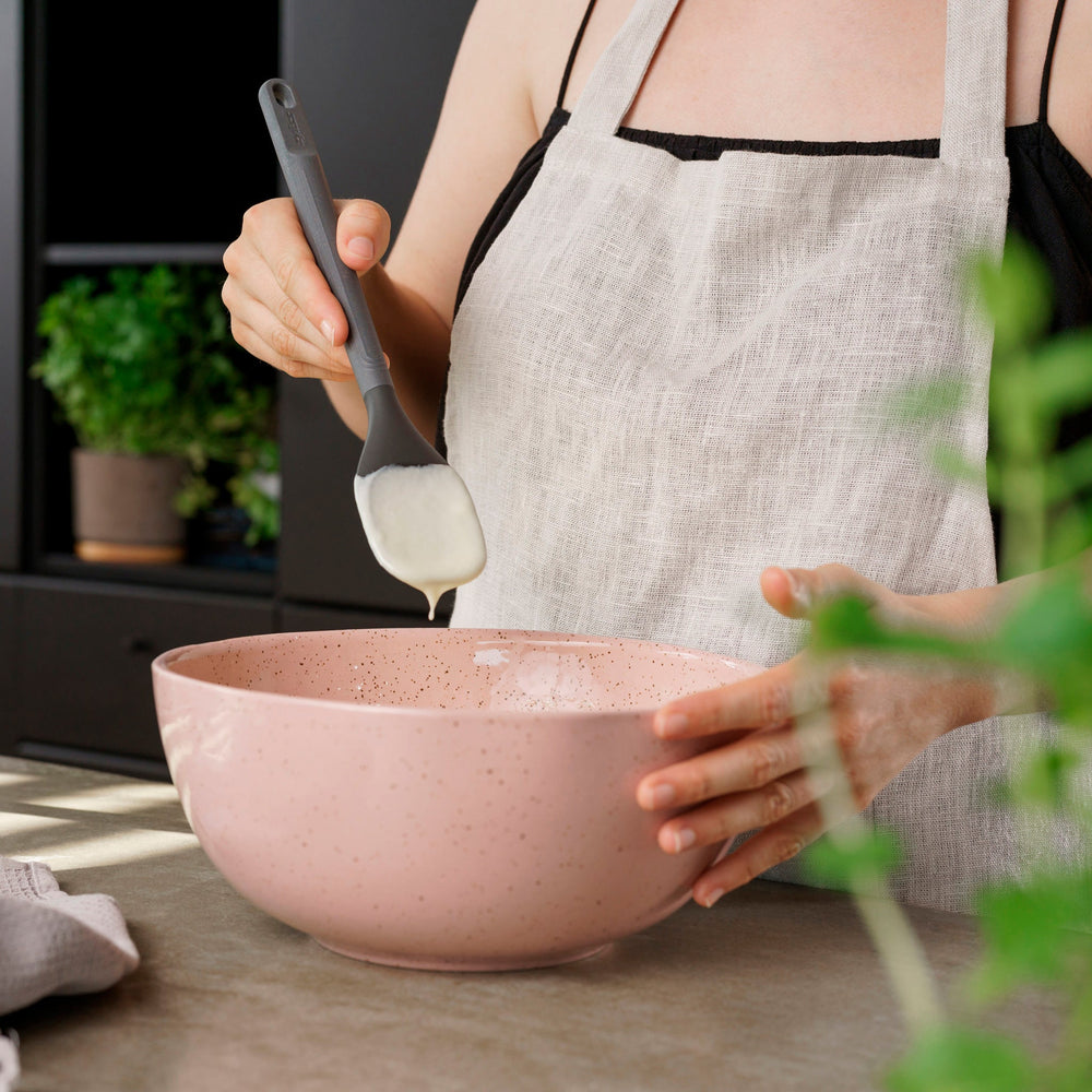 #medium The Zyliss Spoontula is dark gray, with a silicone head, long ergonomic handle, and a gently rounded rectangular bowl, pictured on a plain light background. #Medium