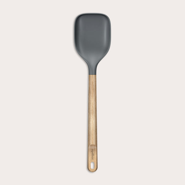 The Zyliss Oak Wood Spoon Large features a gray silicone head, an oak wood handle with a hanging hole, and is shown on a plain white background—a versatile utensil for home cooks.