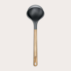 The Zyliss Oak Wood Ladle Large is black with a gray rim and a long oak handle featuring a hanging hole, displayed on a plain light background.