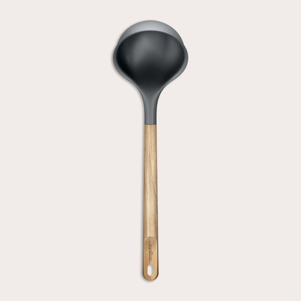 The Zyliss Oak Wood Ladle Large is black with a gray rim and a long oak handle featuring a hanging hole, displayed on a plain light background.