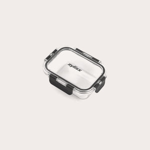#0.37L/0.39qt A small, clear rectangular Zyliss Glass Container with a black latch on the front and sides ensures a secure seal. The lid is printed with Zyliss. Shown empty against a white background, its perfect for meal prep. 