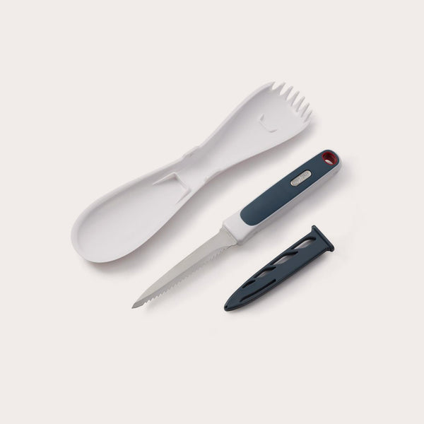The Zyliss 3 In 1 Pumpkin & Squash Scoop & Knife set features a white plastic spork, spoon, serrated knife with black handle—ideal for pumpkin carving—and a black knife sheath, all arranged on a light background. 